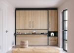 Folding bed with integrated desk and wardrobe